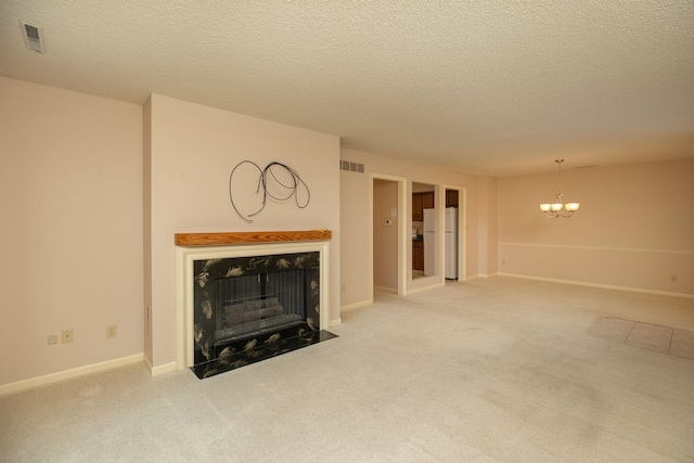2051 Carriage Dr SW Unit 2051E, Rochester, MN 55902 - unfurnished living room featuring a fireplace with flush hearth, carpet floors, a chandelier, and a textured ceiling