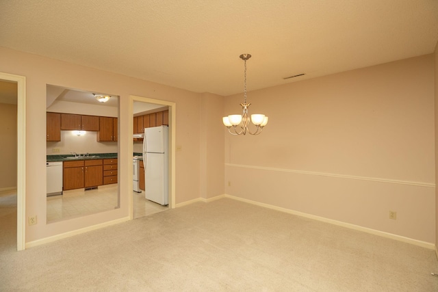 2051 Carriage Dr SW Unit 2051E, Rochester, MN 55902 - unfurnished dining area with light colored carpet and a chandelier