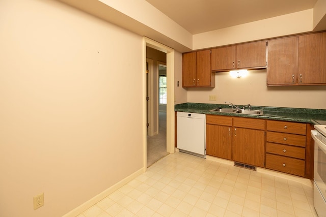 2051 Carriage Dr SW Unit 2051E, Rochester, MN 55902 - kitchen with white appliances, dark countertops, and brown cabinets