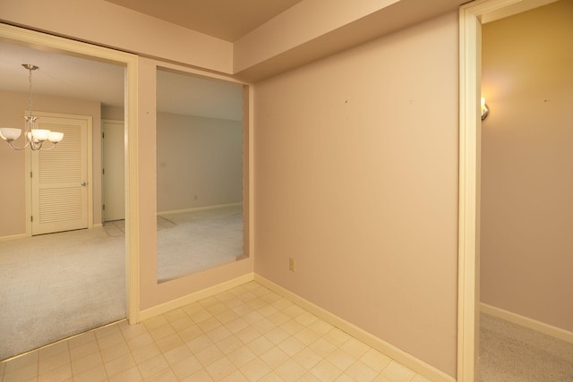 2051 Carriage Dr SW Unit 2051E, Rochester, MN 55902 - spare room featuring a chandelier and carpet floors