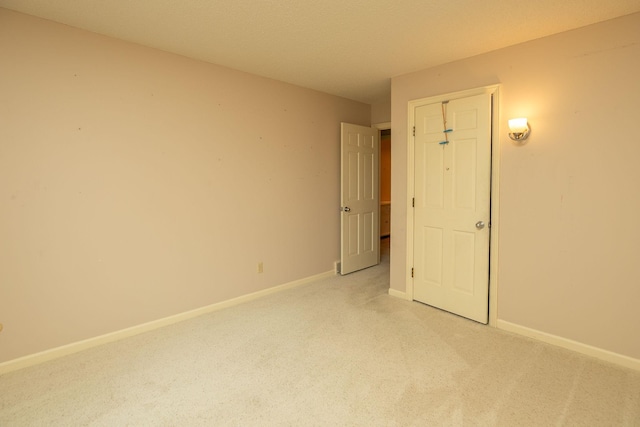 2051 Carriage Dr SW Unit 2051E, Rochester, MN 55902 - spare room with light carpet and baseboards
