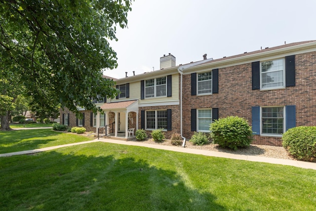 2051 Carriage Dr SW Unit 2051E, Rochester, MN 55902 - view of front of home featuring a chimney, a front yard, and brick siding