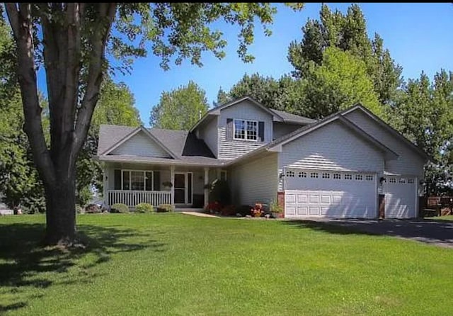 23501 Birch Cir, Rogers, MN 55374 - traditional home with a porch, a garage, a front yard, and asphalt driveway