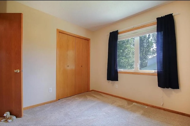 23501 Birch Cir, Rogers, MN 55374 - unfurnished bedroom featuring carpet flooring, a closet, and baseboards