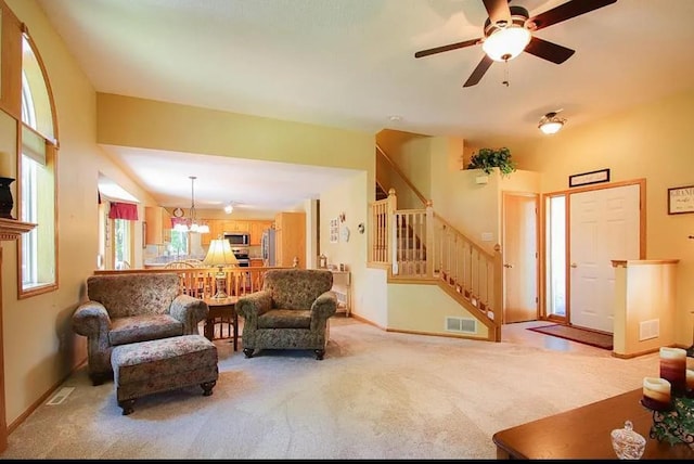 23501 Birch Cir, Rogers, MN 55374 - carpeted living room with stairs, a chandelier, ceiling fan, and baseboards