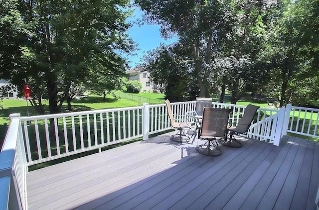 23501 Birch Cir, Rogers, MN 55374 - wooden deck with outdoor dining space and a lawn