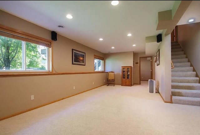 23501 Birch Cir, Rogers, MN 55374 - below grade area featuring recessed lighting, stairway, plenty of natural light, light carpet, and baseboards