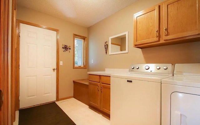 23501 Birch Cir, Rogers, MN 55374 - laundry area with cabinet space, washer and clothes dryer, and a textured ceiling
