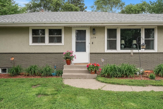 179 County Road F W, Shoreview, MN 55126 - view of front of house featuring stucco siding, a front lawn, and a shingled roof