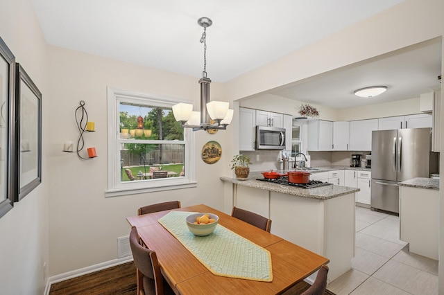 179 County Road F W, Shoreview, MN 55126 - dining area with a chandelier and baseboards