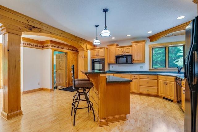 278 Vanity Dr, Shelby Twp, WI 54658 - kitchen with black appliances, light wood-style flooring, a breakfast bar area, recessed lighting, and a sink