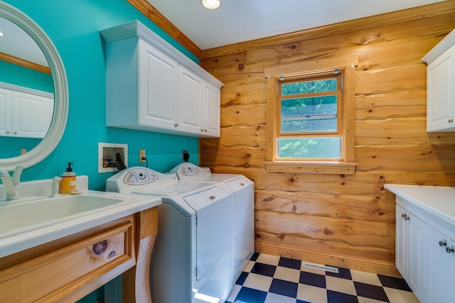 278 Vanity Dr, Shelby Twp, WI 54658 - laundry room with cabinet space, light floors, wood walls, independent washer and dryer, and recessed lighting