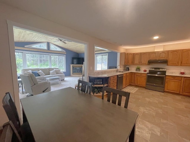16173 Discovery Cir, Park Rapids, MN 56470 - dining room featuring vaulted ceiling, a ceiling fan, a glass covered fireplace, and recessed lighting