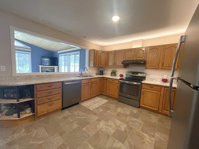 16173 Discovery Cir, Park Rapids, MN 56470 - kitchen with stainless steel appliances, under cabinet range hood, a sink, light countertops, and vaulted ceiling