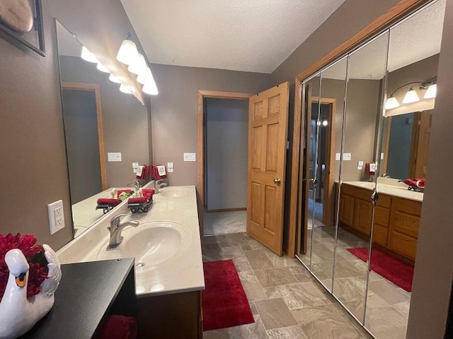 16173 Discovery Cir, Park Rapids, MN 56470 - full bathroom with double vanity, a textured ceiling, and stone finish floors