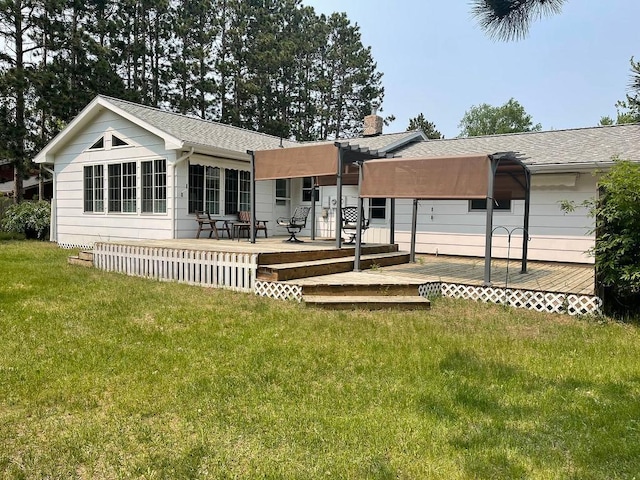 16173 Discovery Cir, Park Rapids, MN 56470 - rear view of house with a deck, a yard, a shingled roof, and a chimney