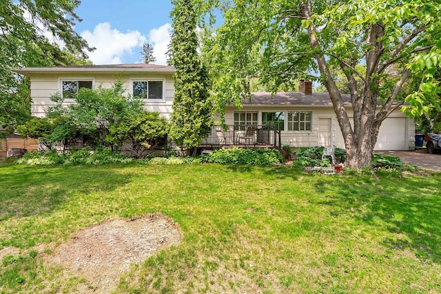 3671 Robinwood Ter, Minnetonka, MN 55305 - view of front of house with a front yard, a chimney, an attached garage, and driveway