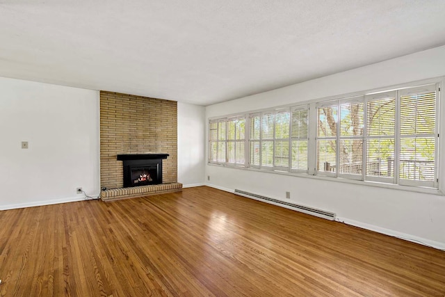 3671 Robinwood Ter, Minnetonka, MN 55305 - unfurnished living room with baseboard heating, baseboards, wood finished floors, and a fireplace