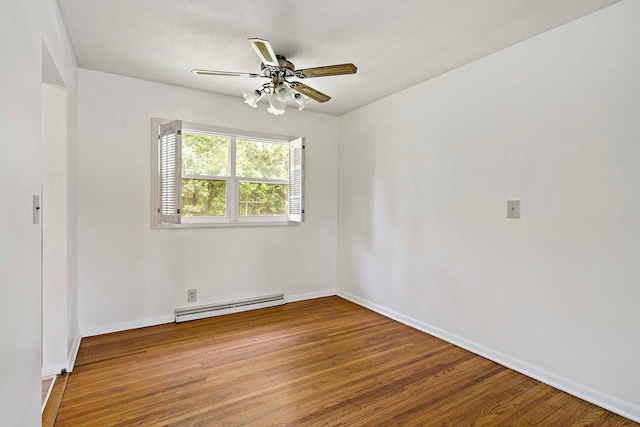 3671 Robinwood Ter, Minnetonka, MN 55305 - empty room featuring baseboard heating, wood finished floors, a ceiling fan, and baseboards
