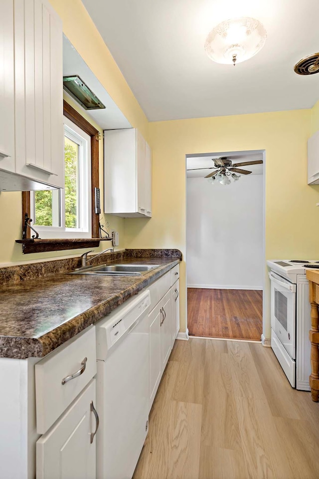 3671 Robinwood Ter, Minnetonka, MN 55305 - kitchen featuring white appliances, dark countertops, light wood-style floors, white cabinets, and a sink