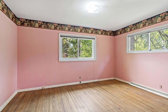 3671 Robinwood Ter, Minnetonka, MN 55305 - spare room with healthy amount of natural light, baseboards, wood finished floors, and a baseboard radiator