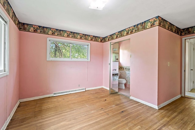 3671 Robinwood Ter, Minnetonka, MN 55305 - spare room with a baseboard heating unit, light wood-style flooring, and baseboards