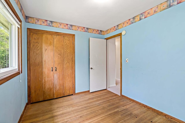 3671 Robinwood Ter, Minnetonka, MN 55305 - unfurnished bedroom featuring a closet, wood finished floors, and baseboards