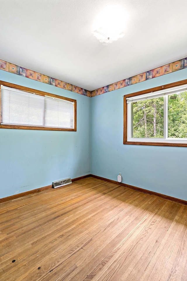 3671 Robinwood Ter, Minnetonka, MN 55305 - spare room featuring wood finished floors and baseboards