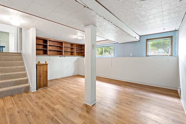 3671 Robinwood Ter, Minnetonka, MN 55305 - below grade area featuring healthy amount of natural light, light wood-type flooring, and stairs