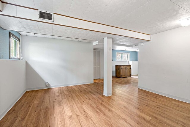 3671 Robinwood Ter, Minnetonka, MN 55305 - below grade area with light wood-type flooring, plenty of natural light, and baseboards