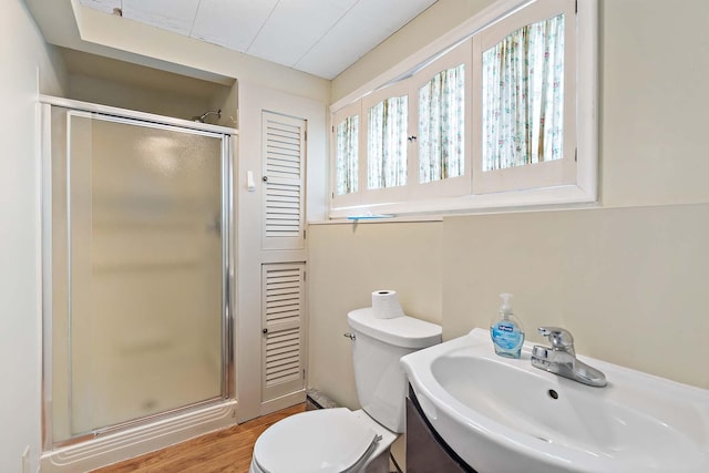 3671 Robinwood Ter, Minnetonka, MN 55305 - full bathroom featuring a shower stall, toilet, wood finished floors, and vanity