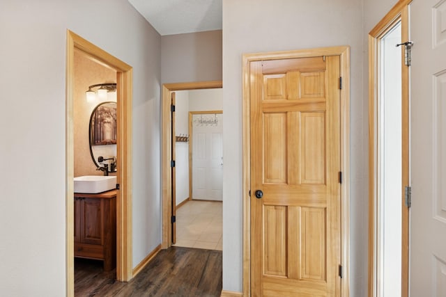 14057 Flintwood Ct, Apple Valley, MN 55124 - hallway with a sink and dark wood-style flooring