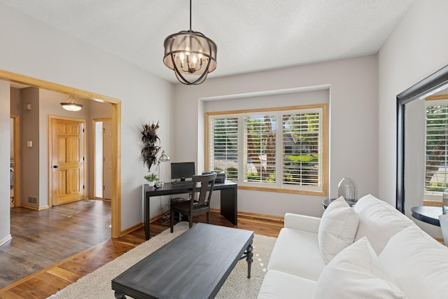 14057 Flintwood Ct, Apple Valley, MN 55124 - office with wood finished floors and a chandelier