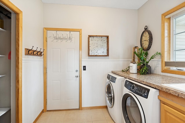 14057 Flintwood Ct, Apple Valley, MN 55124 - washroom featuring wainscoting, independent washer and dryer, and light tile patterned flooring