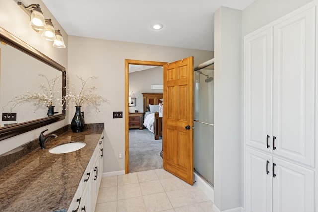 14057 Flintwood Ct, Apple Valley, MN 55124 - ensuite bathroom featuring vanity, a stall shower, tile patterned flooring, and recessed lighting