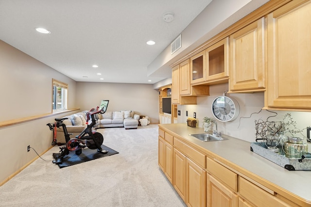 14057 Flintwood Ct, Apple Valley, MN 55124 - kitchen featuring light brown cabinets, light colored carpet, recessed lighting, light countertops, and glass insert cabinets