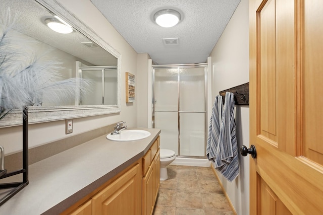 14057 Flintwood Ct, Apple Valley, MN 55124 - bathroom with a shower stall, vanity, and a textured ceiling