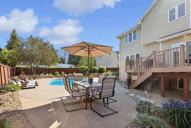 14057 Flintwood Ct, Apple Valley, MN 55124 - fenced backyard featuring a patio area, a wooden deck, stairway, and outdoor dining area