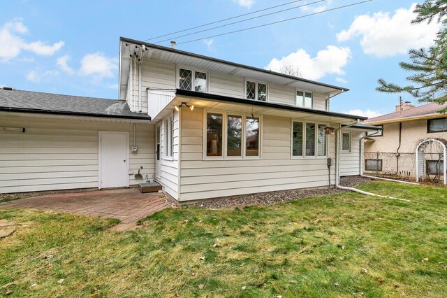 3004 36th Ave NE, Saint Anthony, MN 55418 - back of house with a lawn and a patio