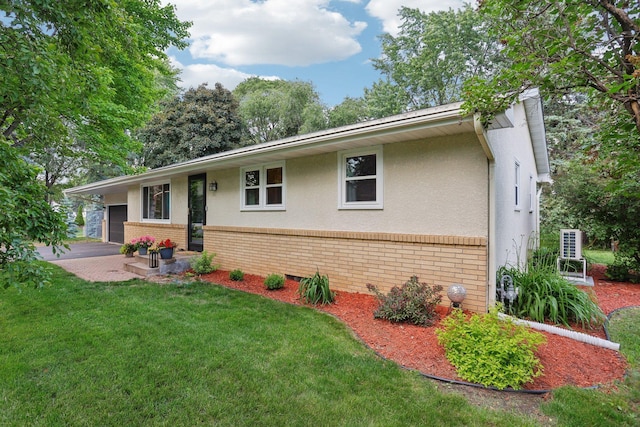 9320 Revere Ln N, Maple Grove, MN 55369 - view of front of home featuring brick siding, a front lawn, and stucco siding