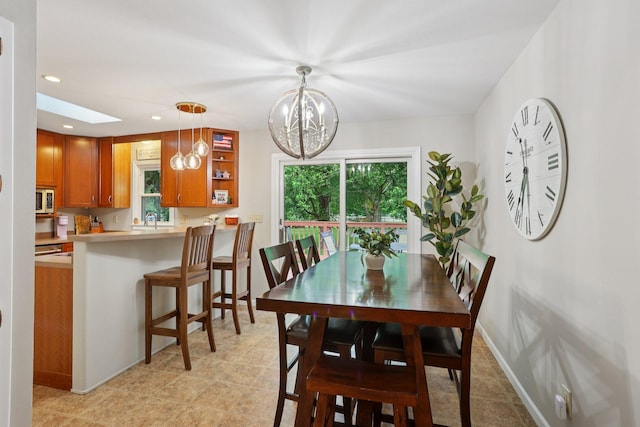 9320 Revere Ln N, Maple Grove, MN 55369 - dining area featuring a chandelier, recessed lighting, baseboards, and a skylight