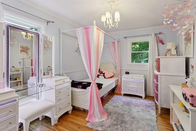 9320 Revere Ln N, Maple Grove, MN 55369 - bedroom featuring a chandelier, light wood-type flooring, and crown molding