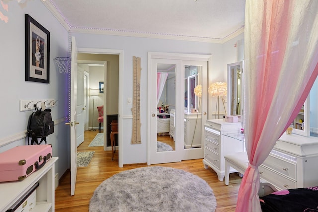9320 Revere Ln N, Maple Grove, MN 55369 - bedroom with crown molding and light wood-style floors