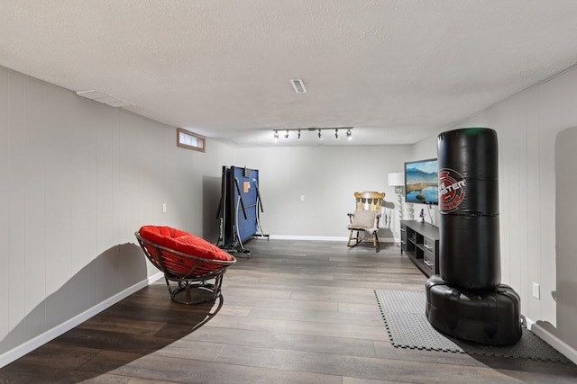 9320 Revere Ln N, Maple Grove, MN 55369 - living area with wood finished floors, baseboards, and a textured ceiling
