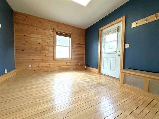 638 James St, Ely, MN 55731 - unfurnished room featuring healthy amount of natural light, wood walls, and wood-type flooring
