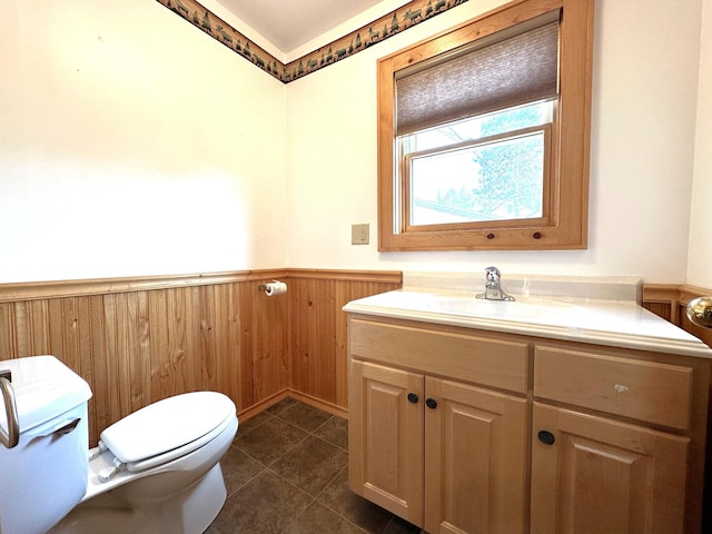 638 James St, Ely, MN 55731 - bathroom featuring toilet, a wainscoted wall, vanity, and tile patterned floors