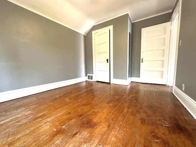 638 James St, Ely, MN 55731 - empty room with wood-type flooring, baseboards, ornamental molding, and lofted ceiling