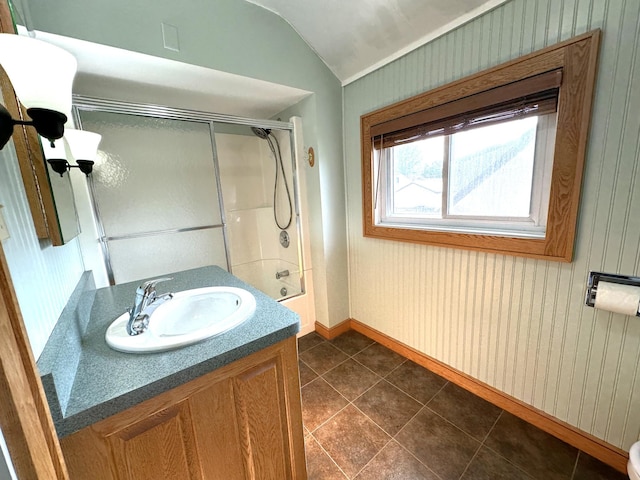 638 James St, Ely, MN 55731 - full bath with baseboards, tile patterned flooring, vanity, shower / bath combination with glass door, and lofted ceiling
