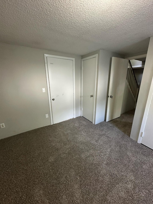 332 Pleasant Ave, Ellsworth, WI 54011 - unfurnished bedroom featuring carpet and a textured ceiling