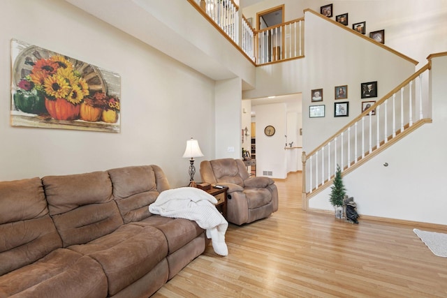 9026 Merrimac Ln N, Maple Grove, MN 55311 - living area with wood finished floors, stairway, a high ceiling, and baseboards